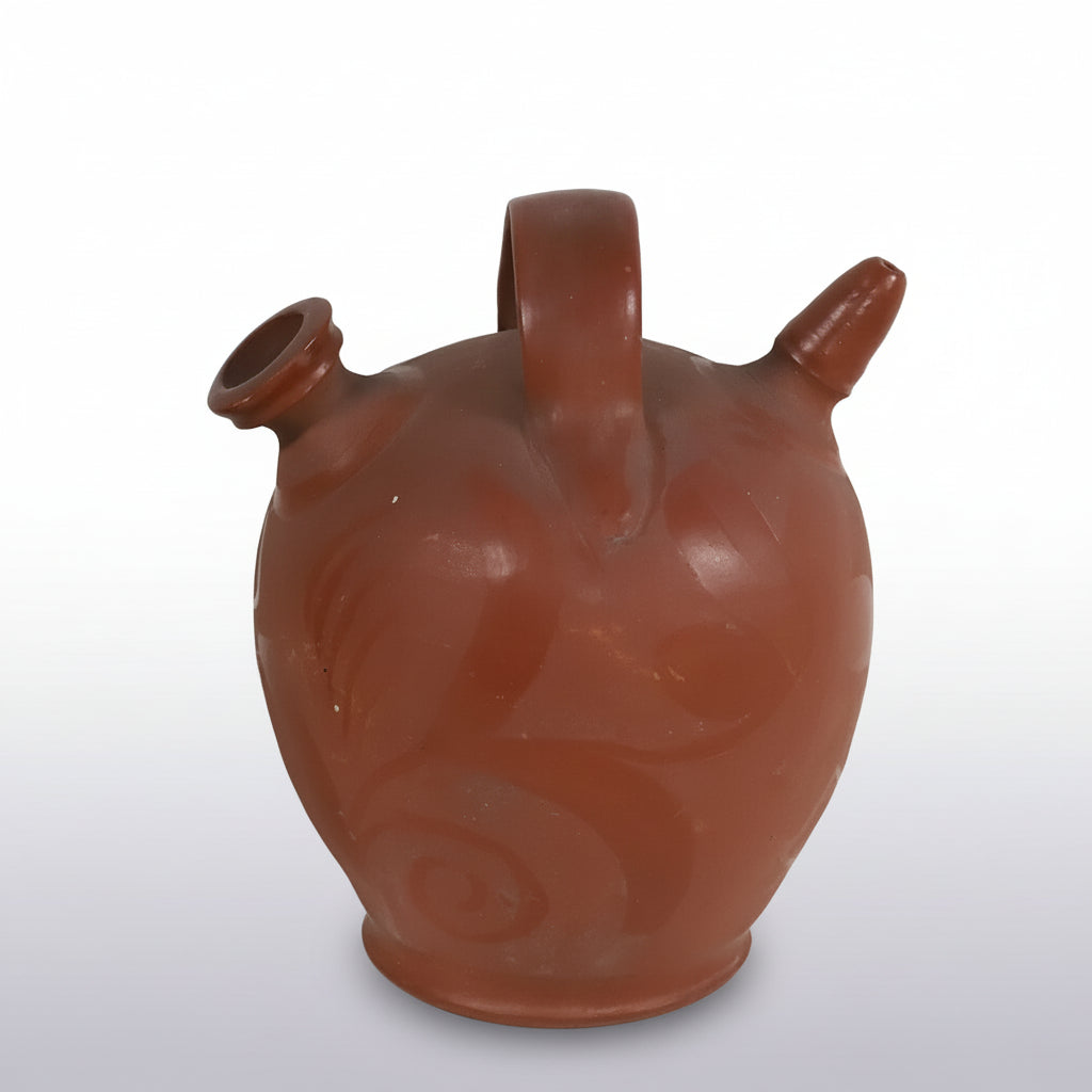 An antique French Provençal gargoulette handcrafted in warm red terracotta.