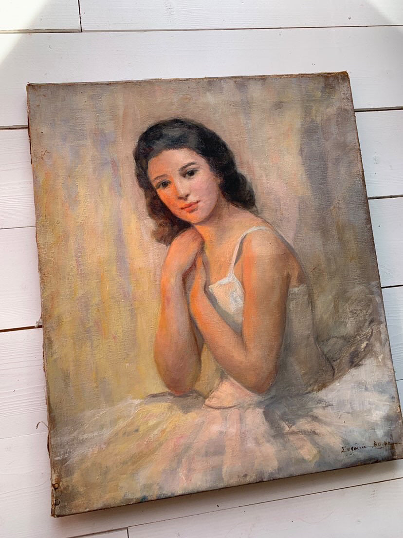 Vintage painting of a woman on a white wooden floor