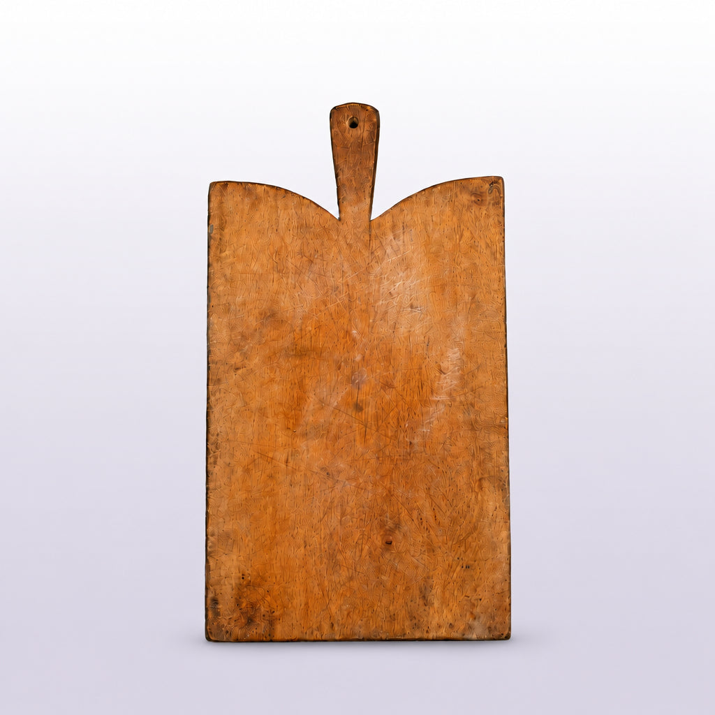 Wooden cutting board with a handle on a black background