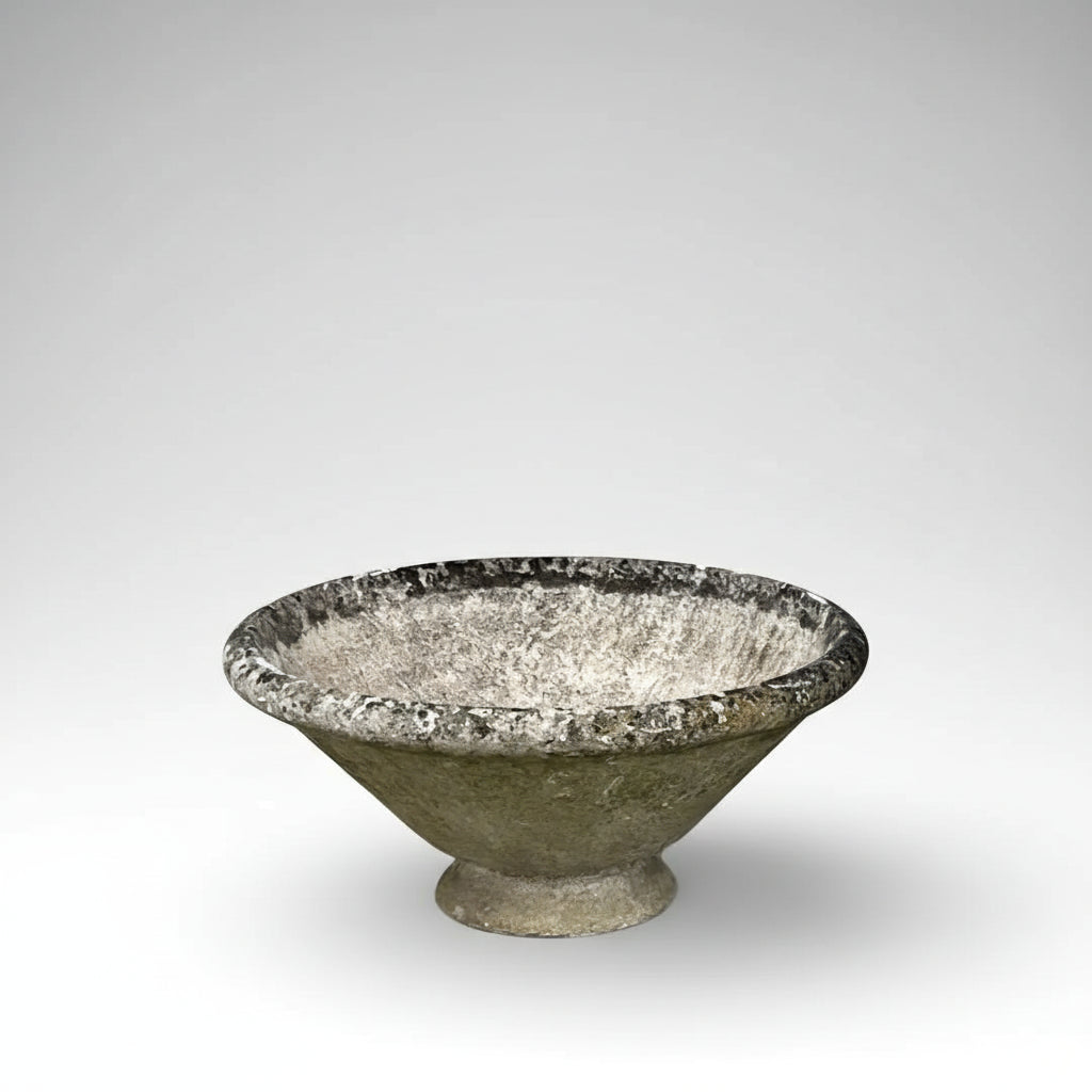 A large planter in cast concrete, its bold conical form and footless base in the minimalist, sculptural style of designer Willy Guhl.