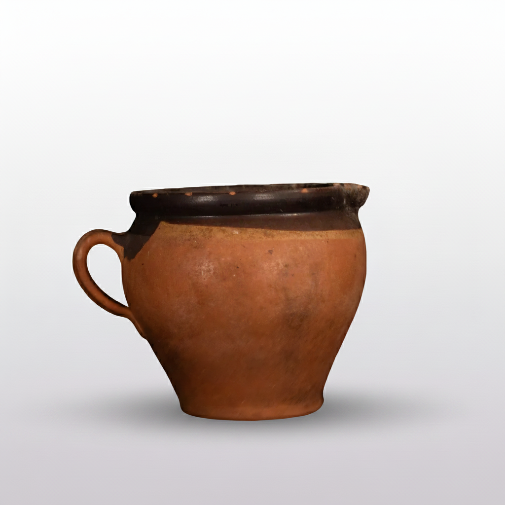Terracotta pot on a black surface with a dark background