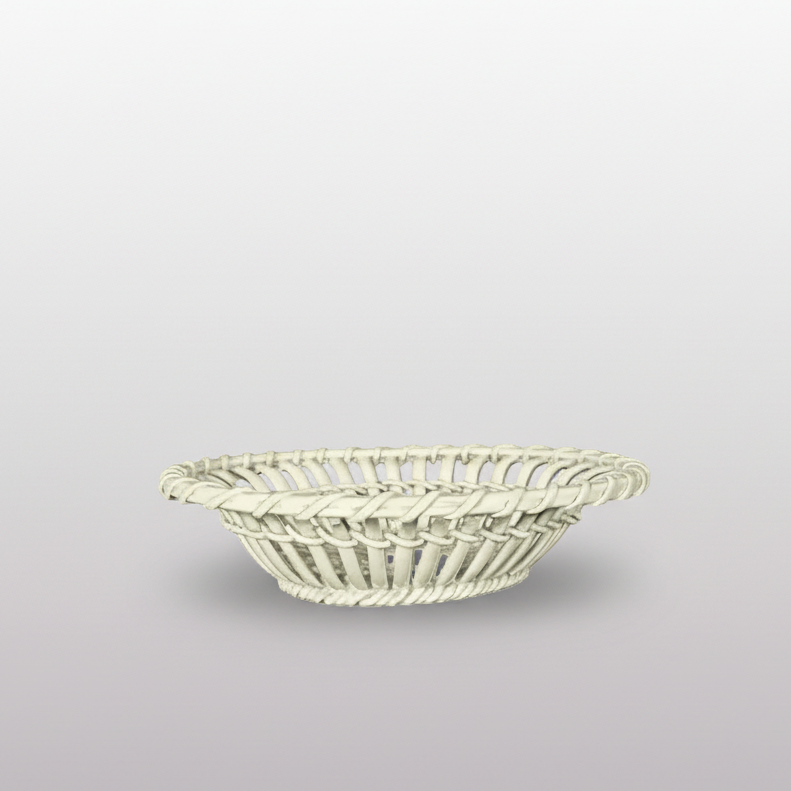 A small white woven basket with a flared rim, photographed on a dark gray surface against a dark gray background.