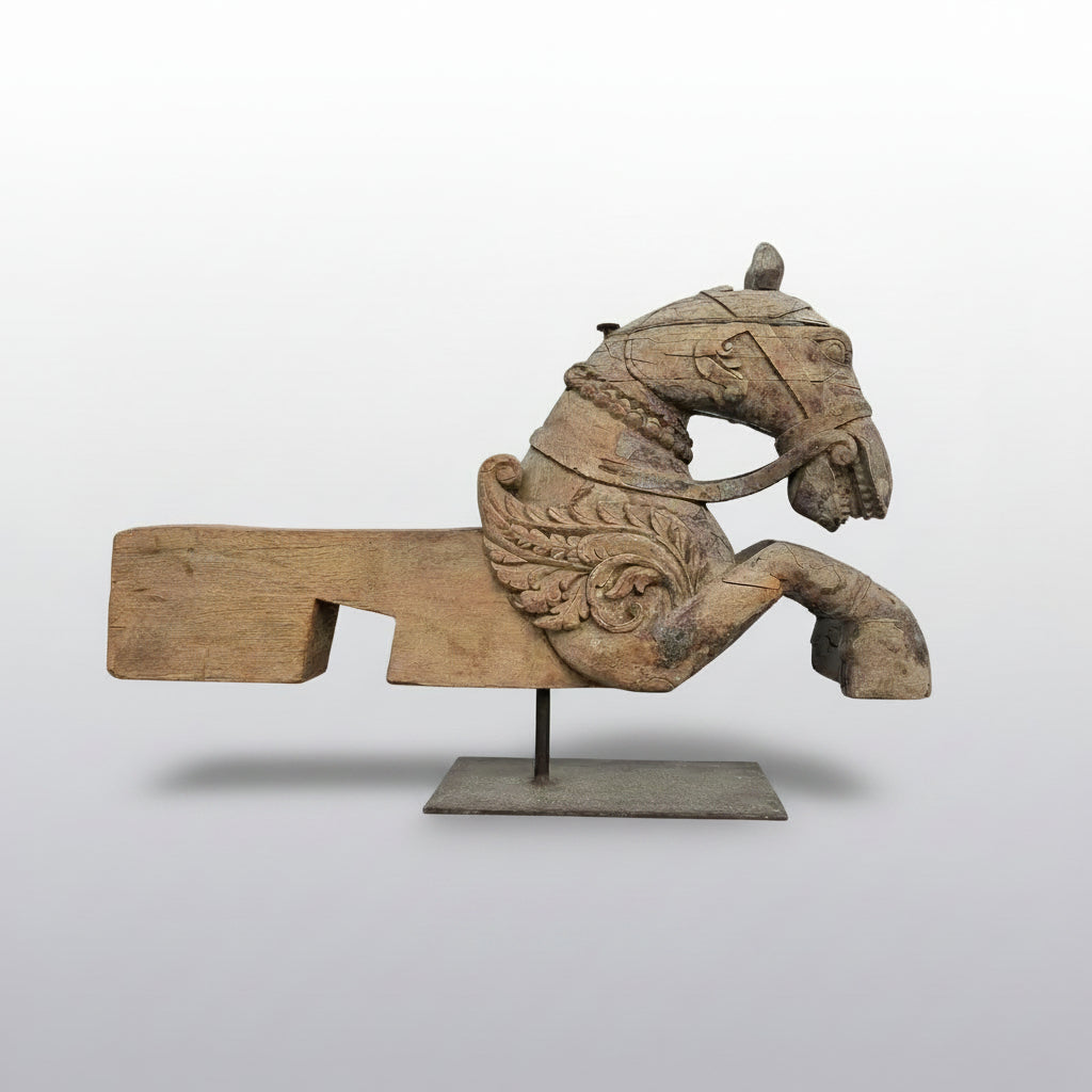 A 19th century carved wood pegasus fragment, likely once part of an architectural or processional element, with an expressive winged form and weathered surface.