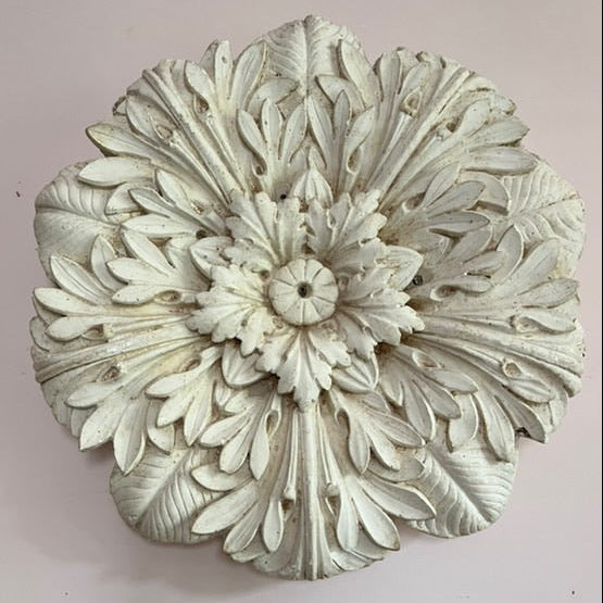 Decorative floral wall piece on a light pink background