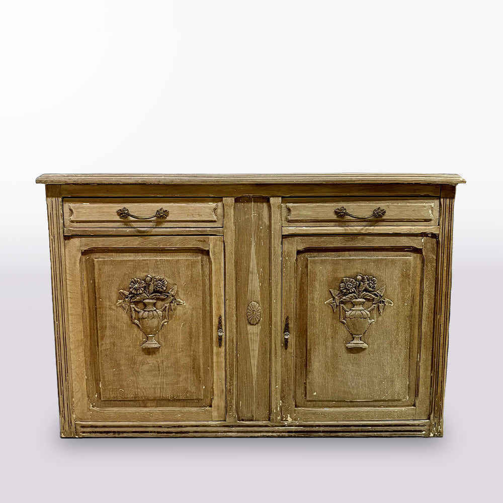 Wooden sideboard with decorative urns on a white wall background.