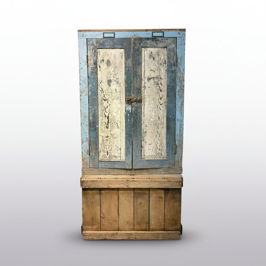 Vintage wooden cabinet with peeling paint in a room with a ladder and another door.