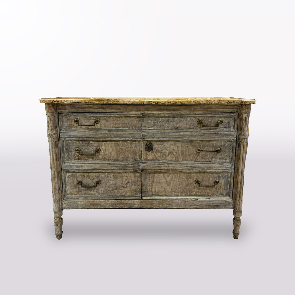 Vintage-style wooden dresser in a store setting with mirrors and other furniture.