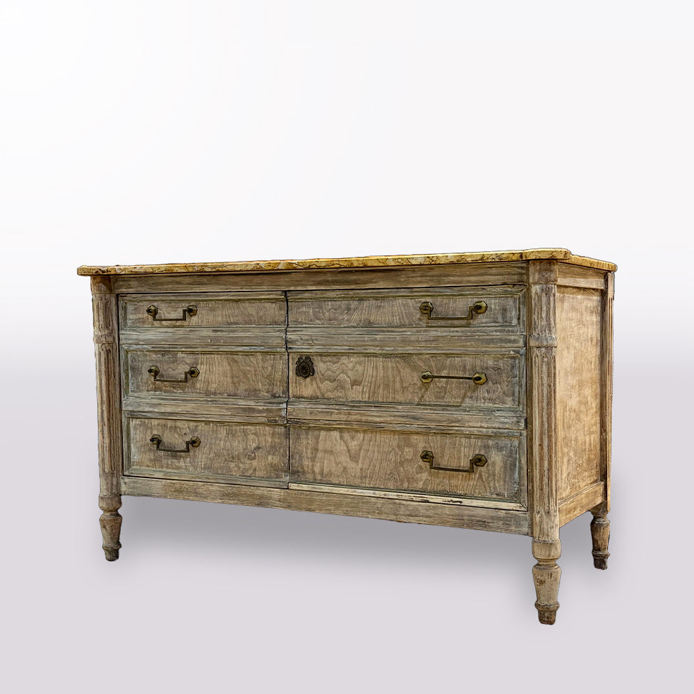 Vintage-style wooden dresser in a store setting with mirrors and other furniture.