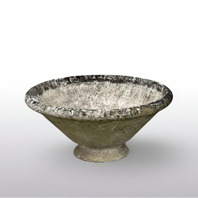 A large planter in cast concrete, its bold conical form and footless base in the minimalist, sculptural style of designer Willy Guhl.